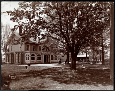 View through the trees of the Woodmansten Inn, Westchester, New York, 1901 by Byron Company